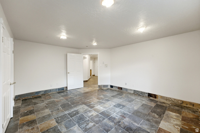 3535 Homestead Road Park City, UT 84098 - Photo 59 of 81 Spacious room featuring slate tile flooring, white walls, and multiple flush-mount ceiling lights