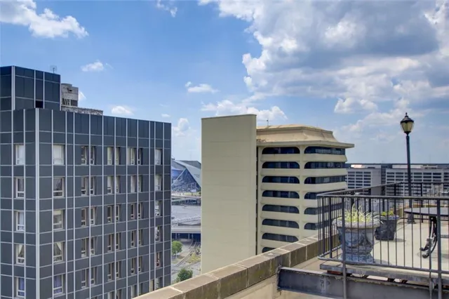 a view of a terrace with furniture and city view