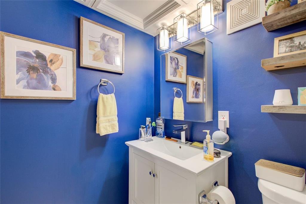 32 Peachtree Street Northwest, Unit 1102 Atlanta, GA 30303 - Photo 20 of 35 a bathroom with a sink mirror and toilet
