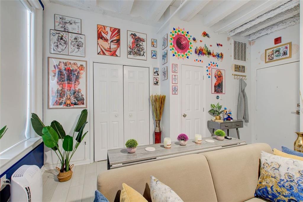 32 Peachtree Street Northwest, Unit 1102 Atlanta, GA 30303 - Photo 23 of 35 a room with a refrigerator a sink and a couch