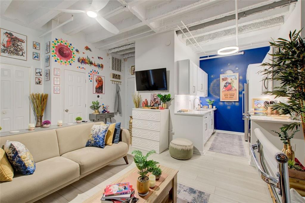 32 Peachtree Street Northwest, Unit 1102 Atlanta, GA 30303 - Photo 25 of 35 a living room with furniture and a flat screen tv