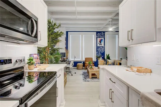 a kitchen with a sink a stove and cabinets