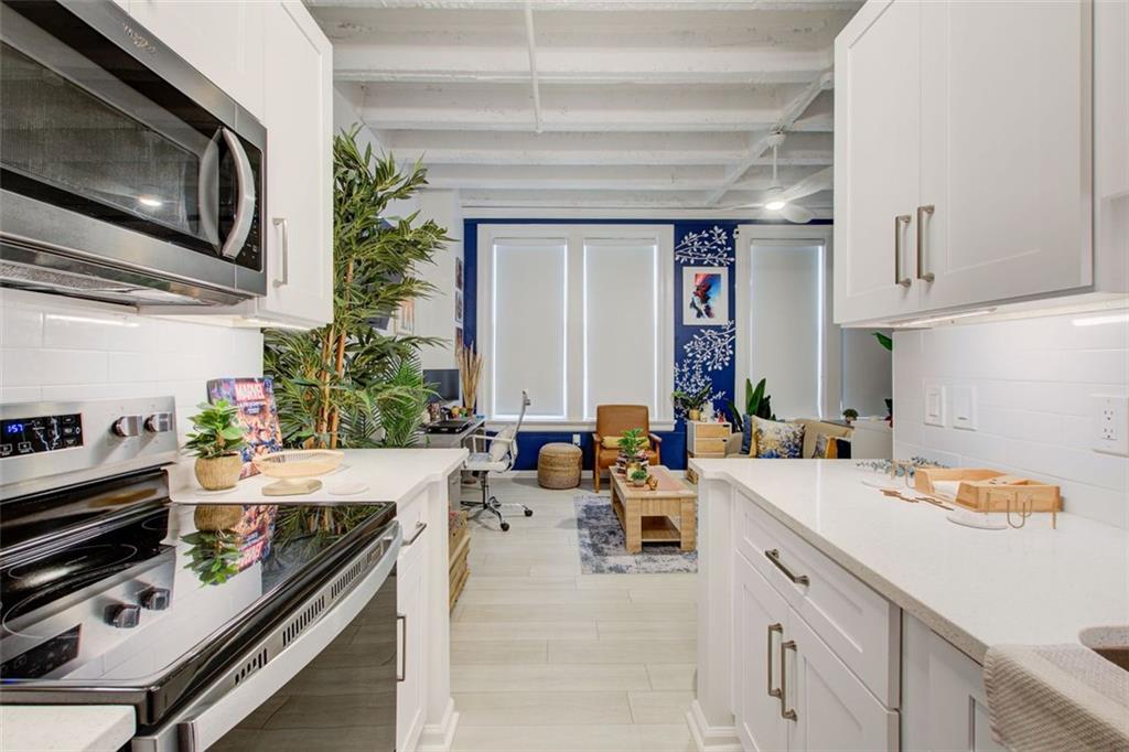 32 Peachtree Street Northwest, Unit 1102 Atlanta, GA 30303 - Photo 26 of 35 a kitchen with a sink stove and cabinets