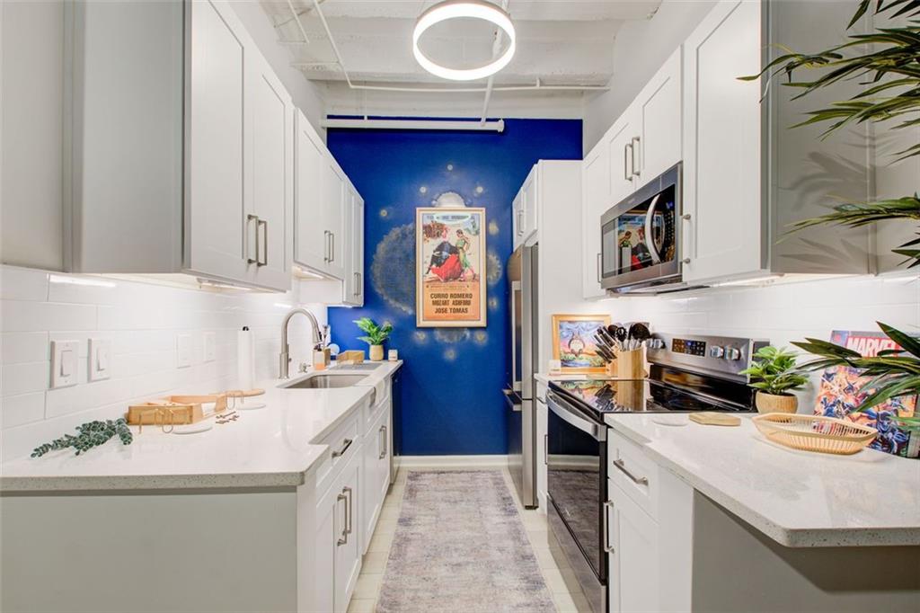 32 Peachtree Street Northwest, Unit 1102 Atlanta, GA 30303 - Photo 28 of 35 a kitchen with a sink a stove and cabinets