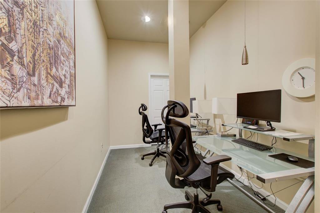 32 Peachtree Street Northwest, Unit 1102 Atlanta, GA 30303 - Photo 3 of 35 a view of a workspace with furniture and a flat screen tv