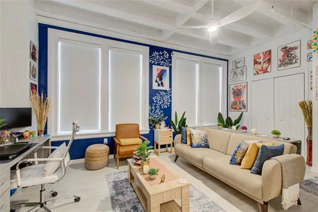 a living room with furniture and flowers