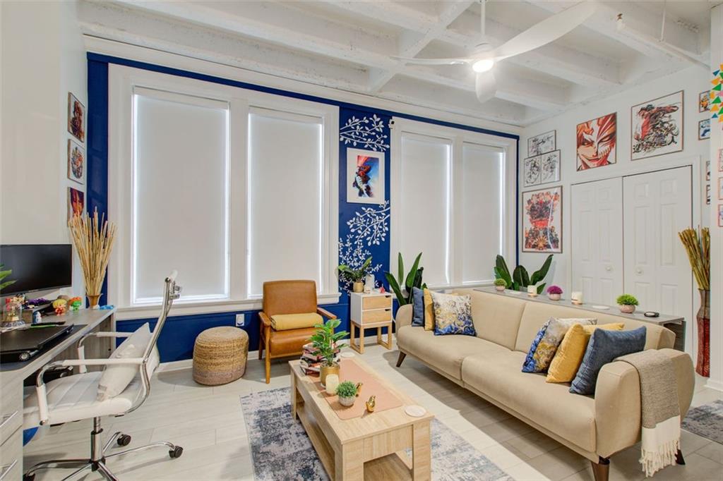 32 Peachtree Street Northwest, Unit 1102 Atlanta, GA 30303 - Photo 32 of 35 a living room with furniture and a flat screen tv