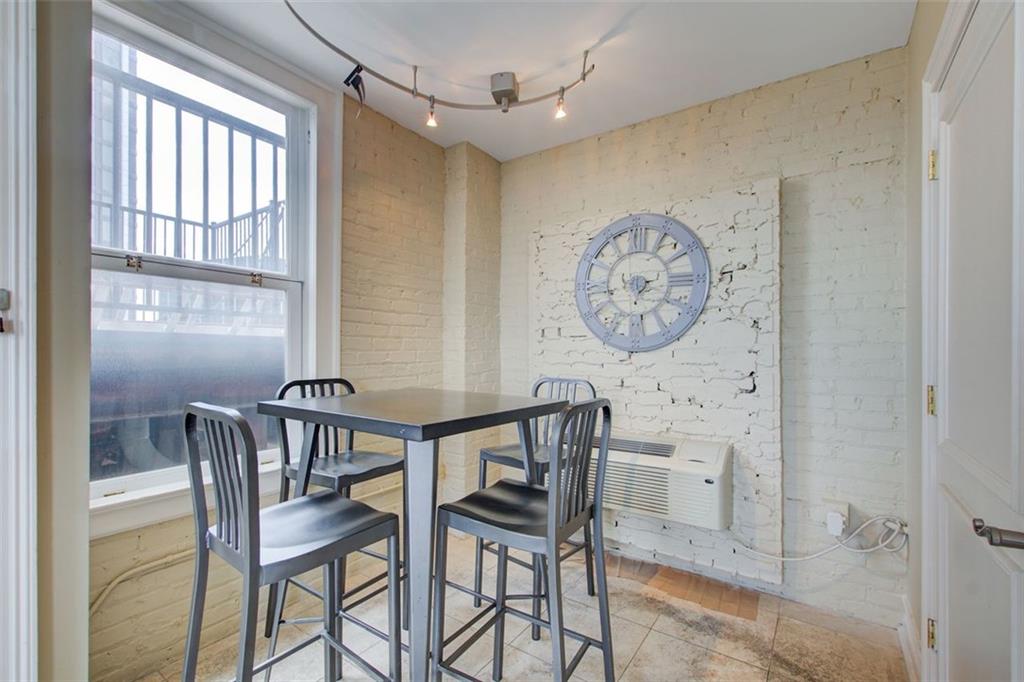 32 Peachtree Street Northwest, Unit 1102 Atlanta, GA 30303 - Photo 6 of 35 a view of a dining room with furniture and a large window