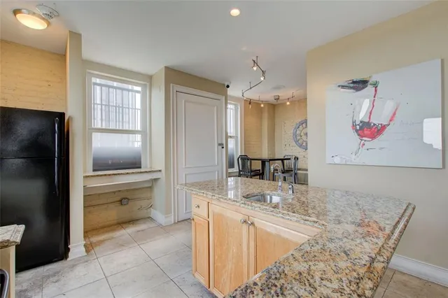 a kitchen with a refrigerator and a sink