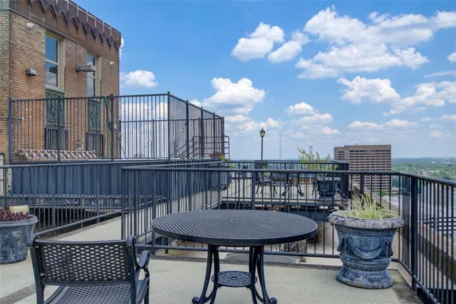 a balcony with table and chairs