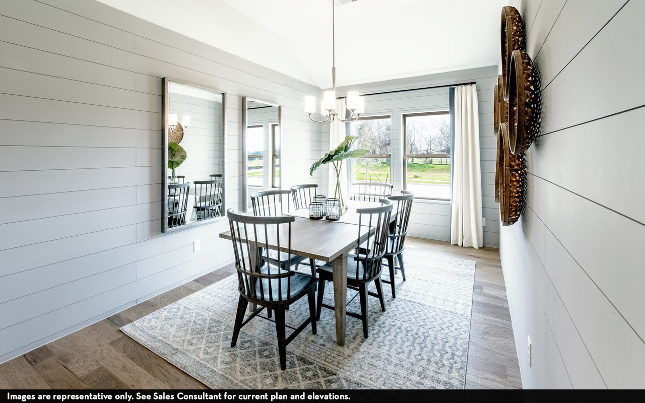 10669 Altitude Way Conroe, TX 77303 - Photo 12 of 20 a view of a dining room with furniture wooden floor and a chandelier