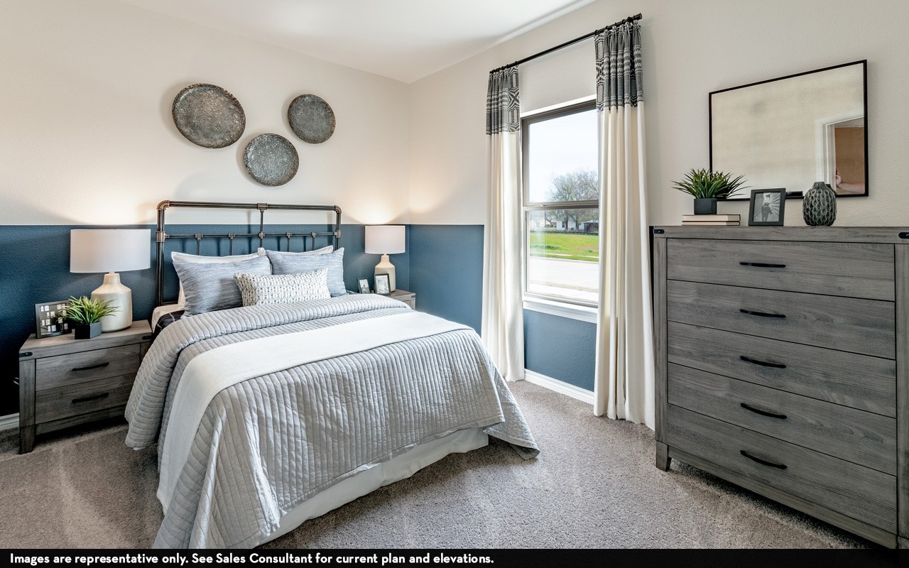 10669 Altitude Way Conroe, TX 77303 - Photo 17 of 20 a bedroom with a large bed and a chandelier