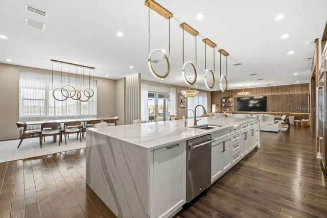 a room with a chandelier furniture and a potted plant