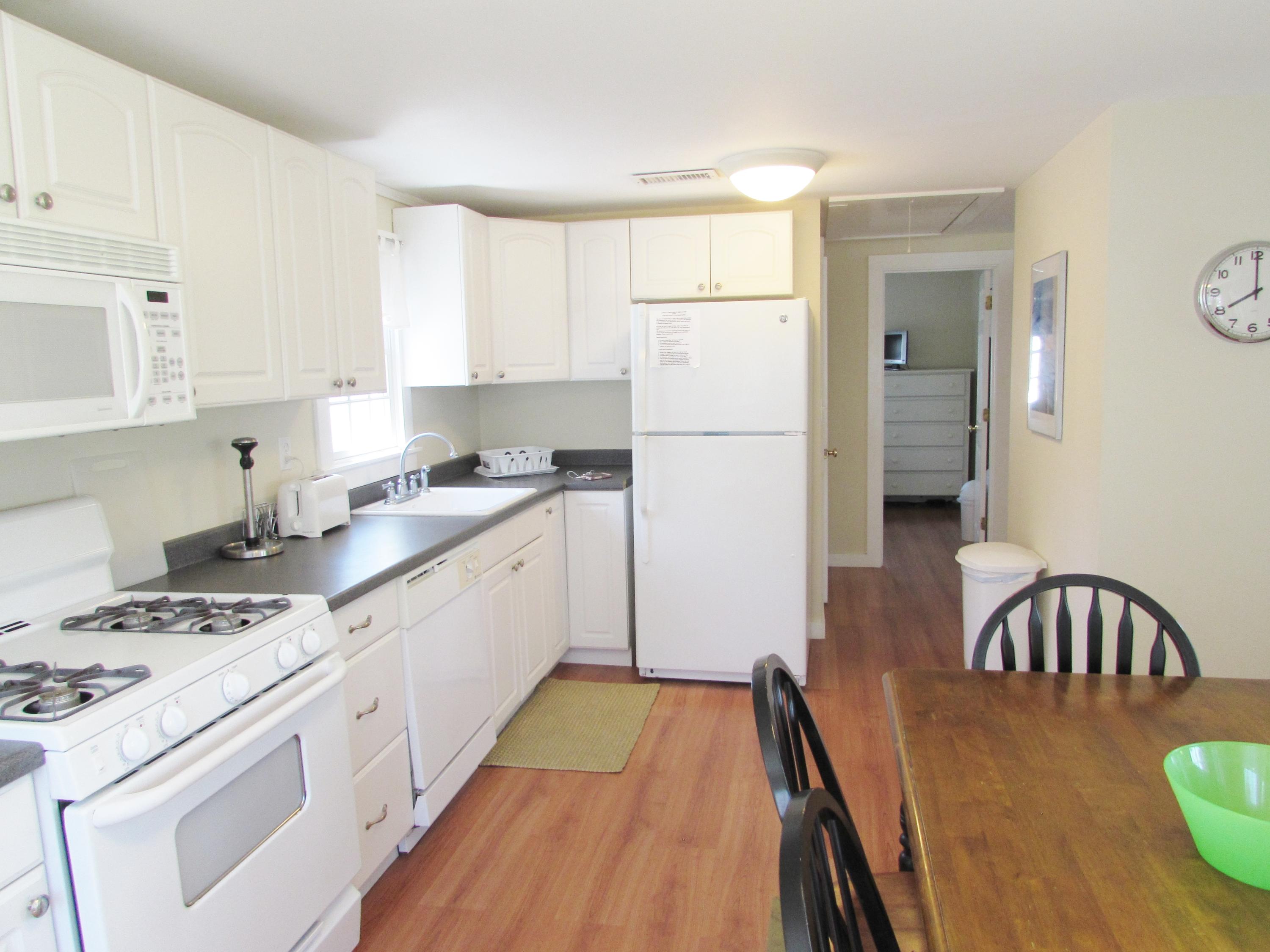 41 Longell Road Dennis Port, MA 02639 - Photo 4 of 14 a kitchen with a table chairs stove and cabinets