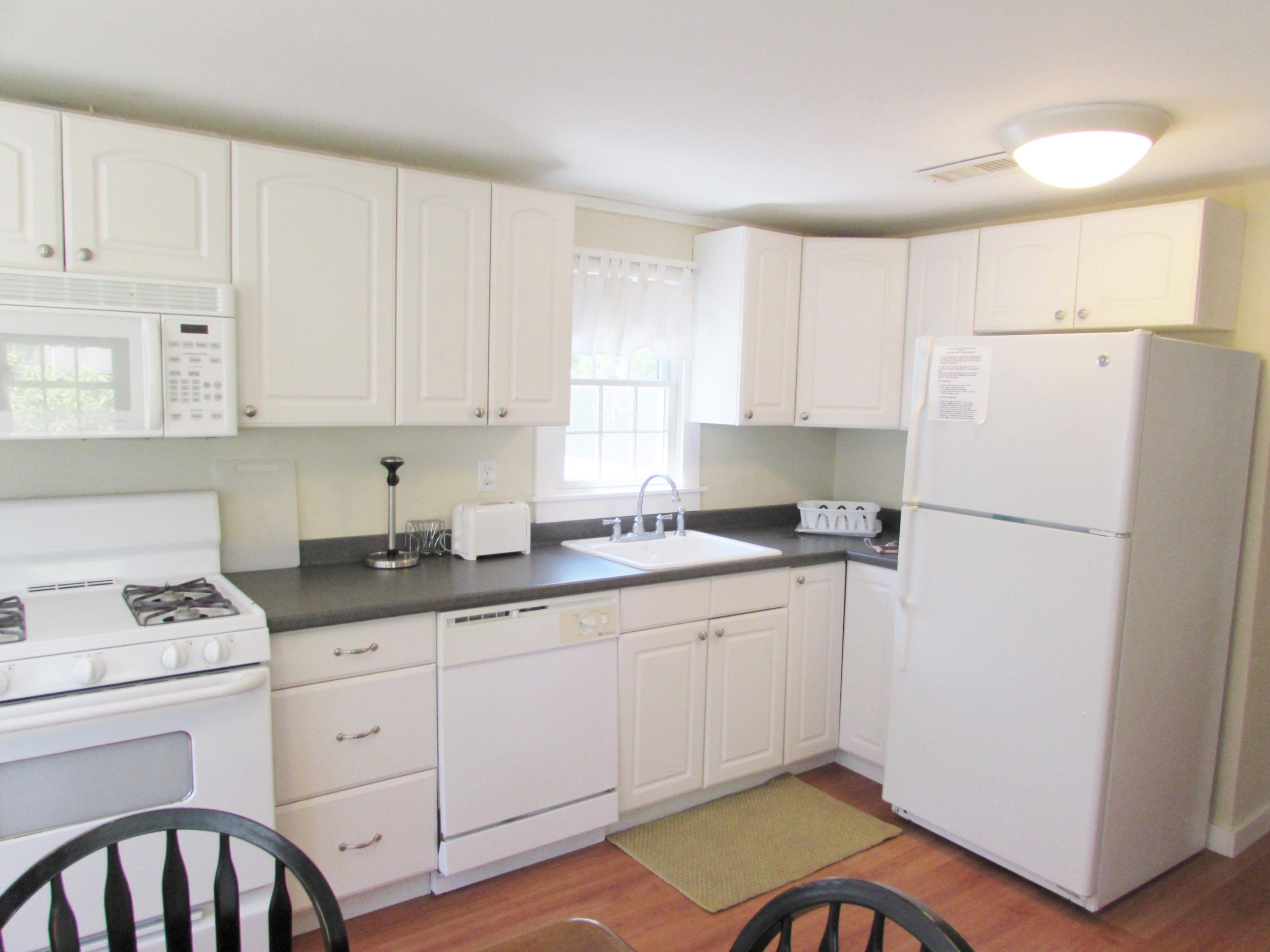 41 Longell Road Dennis Port, MA 02639 - Photo 5 of 14 a kitchen with sink refrigerator and cabinets