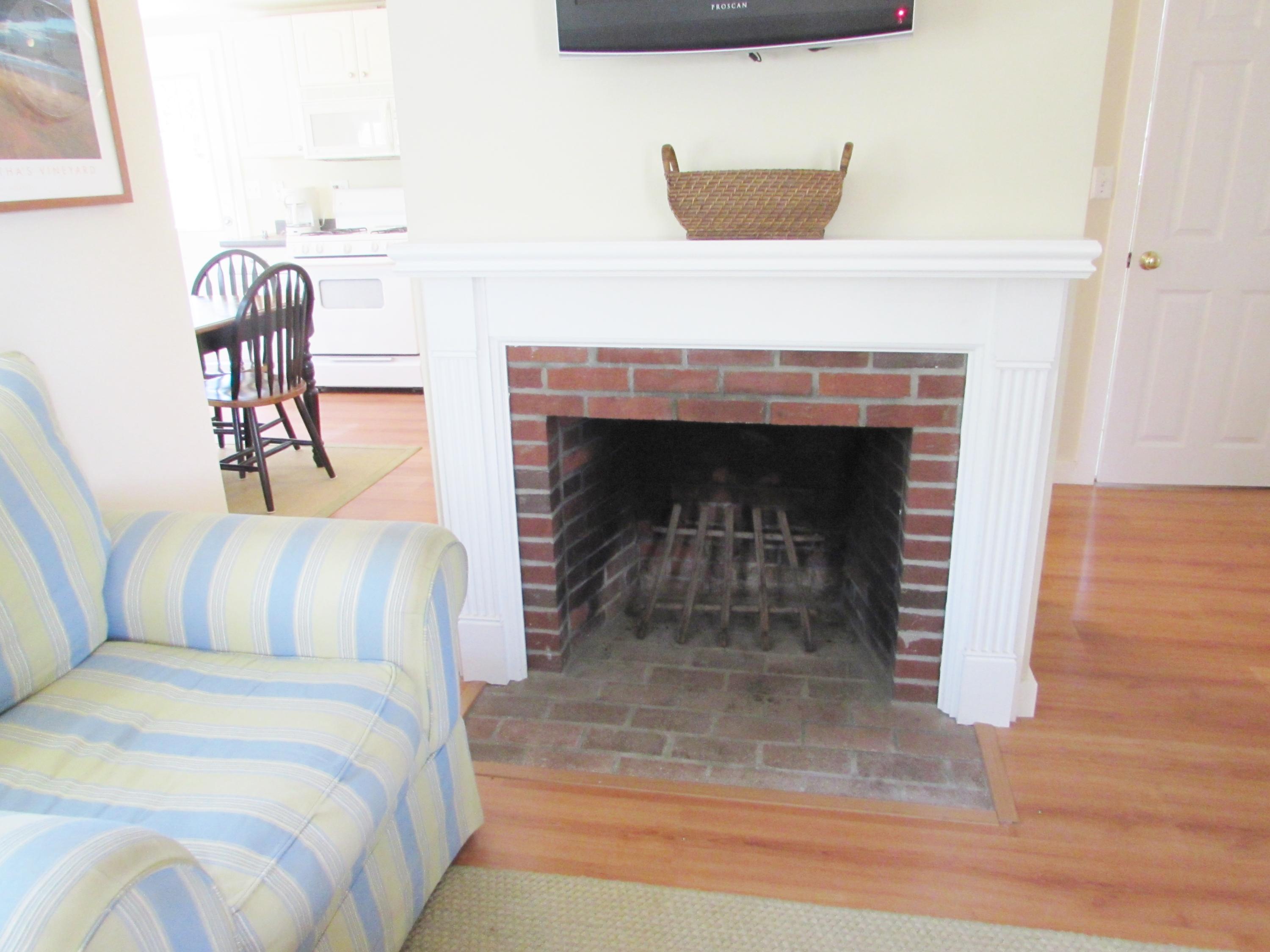 41 Longell Road Dennis Port, MA 02639 - Photo 8 of 14 a bedroom with a bed and a fireplace