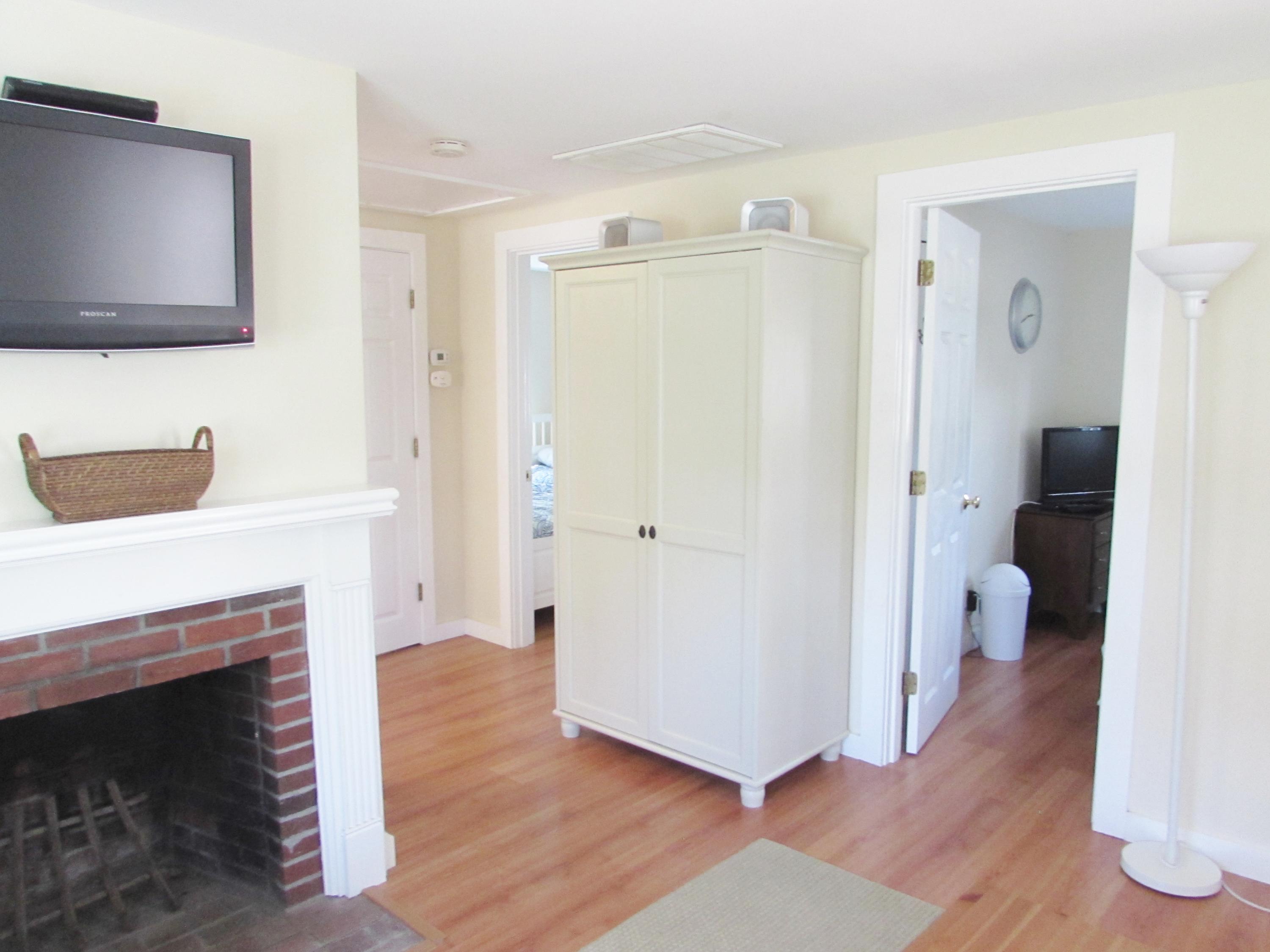 41 Longell Road Dennis Port, MA 02639 - Photo 9 of 14 a hallway with wooden floor a fireplace