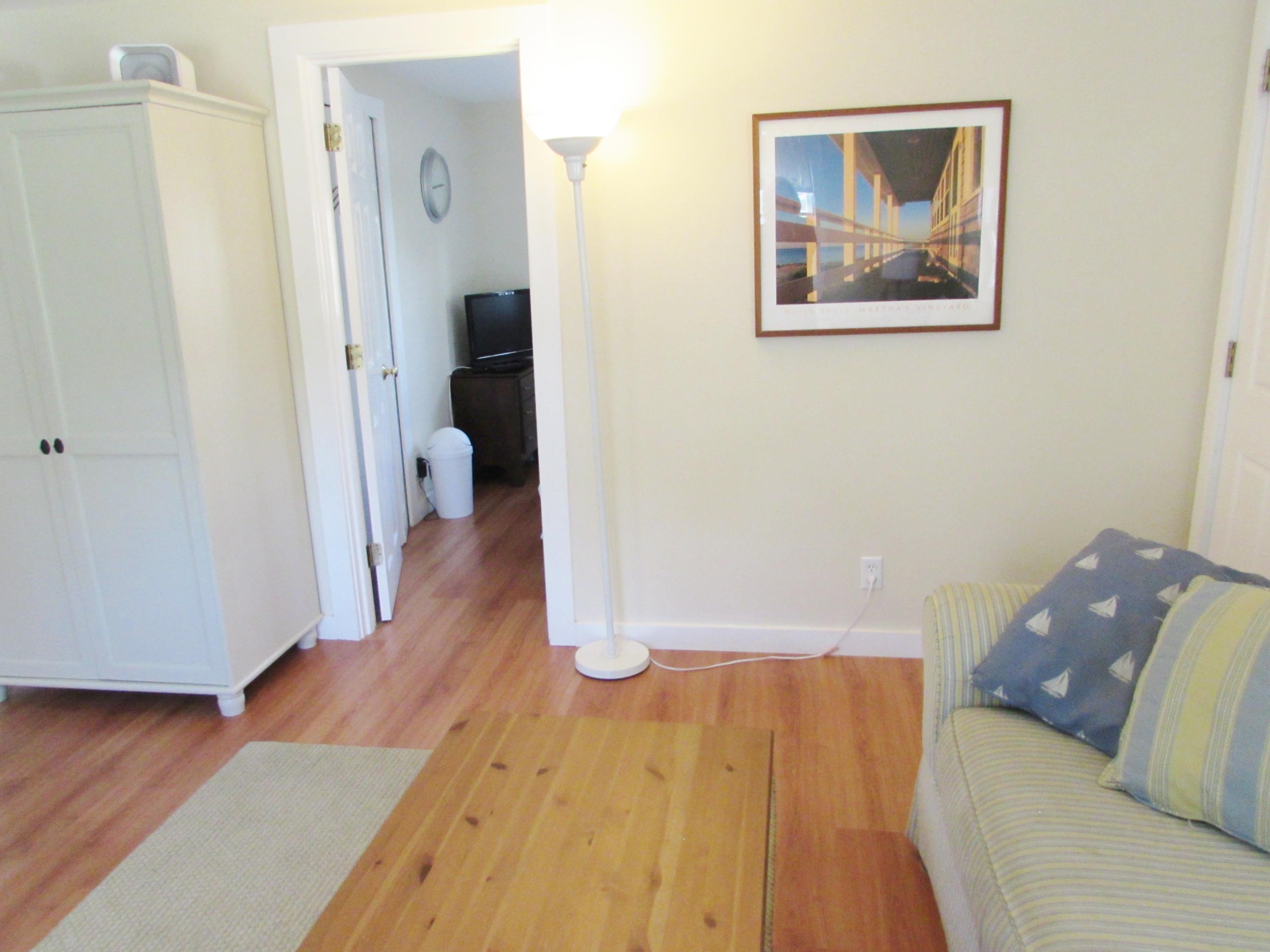 41 Longell Road Dennis Port, MA 02639 - Photo 10 of 14 a living room with wooden floor and a ceiling fan