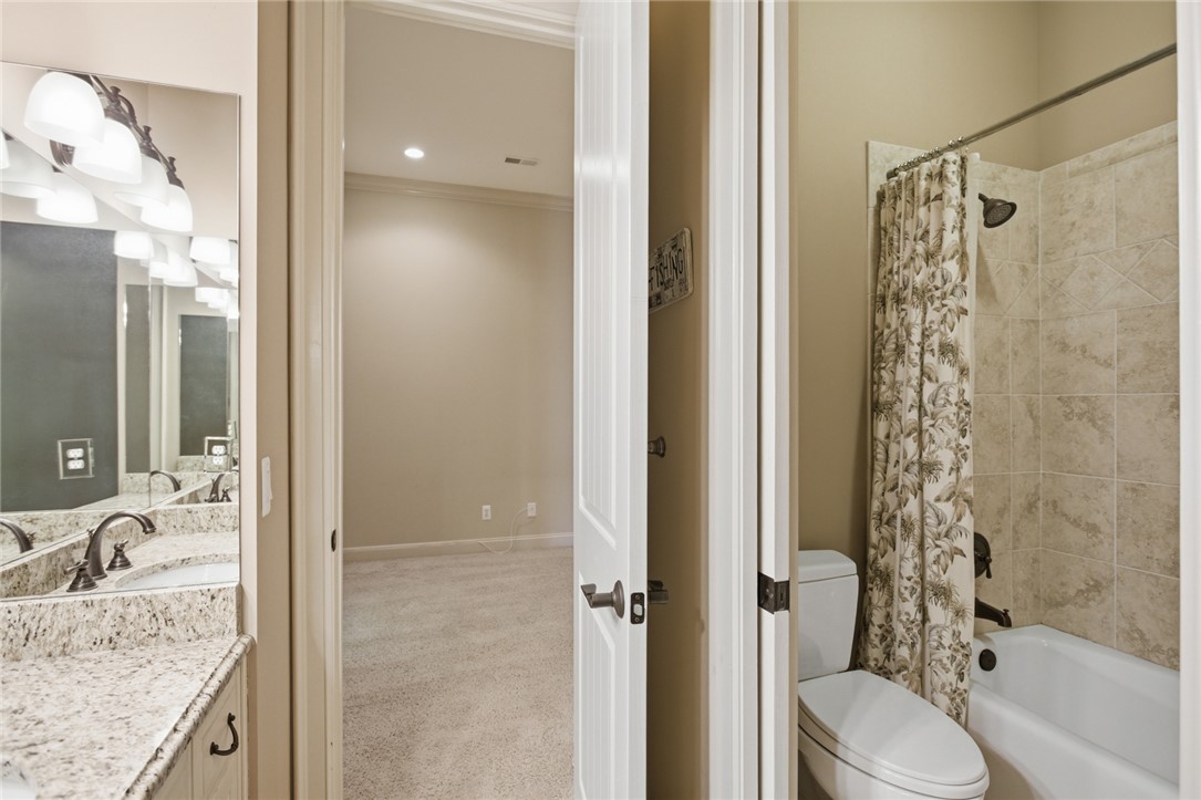 130 River Ridge Road Sunset, SC 29685 - Photo 33 of 47 This bathroom features a double vanity with granite counters and a clean shower-over-tub combination.