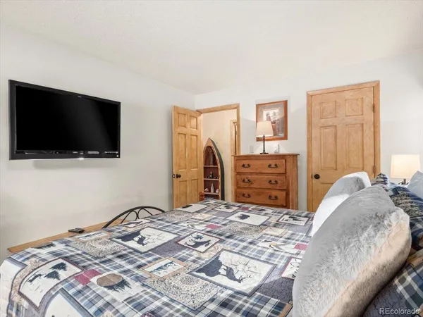 a bedroom with a bed and a flat screen tv