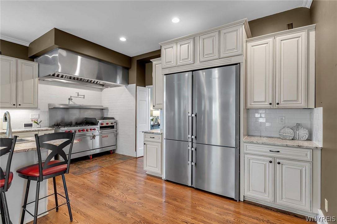 357 Lebrun Road Amherst, NY 14226 - Photo 8 of 50 Commercial gas stove-ovens and exhaust hood with o