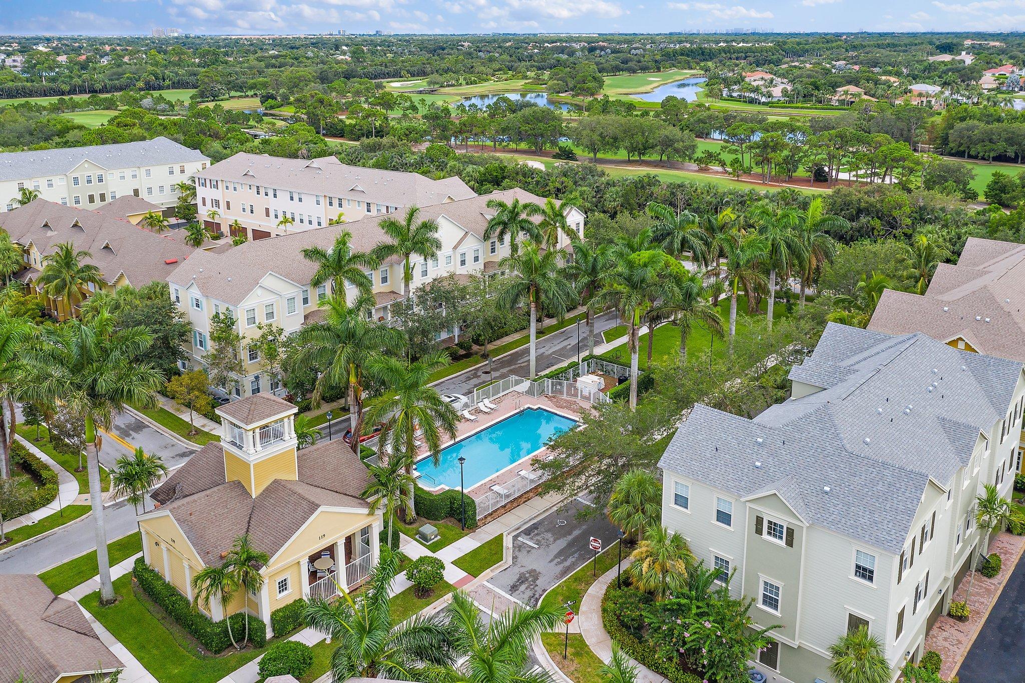 an aerial view of residential houses with outdoor space and street view