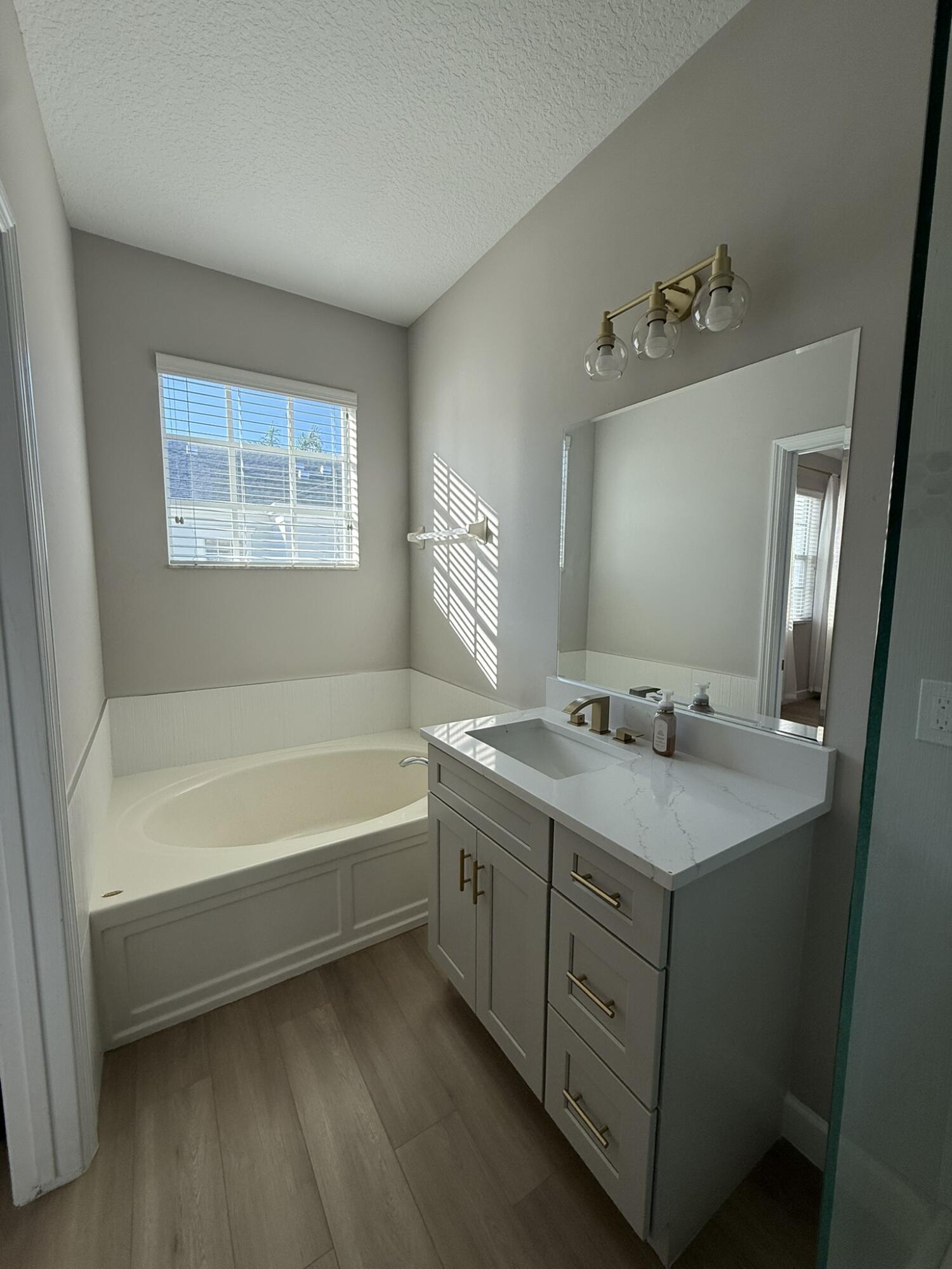 110 Sea Plum Drive, Unit 103 Jupiter, FL 33458 - Photo 20 of 31 a spacious bathroom with a tub sink and mirror