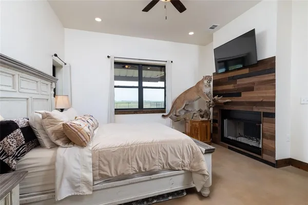 a bedroom with a bed and a television