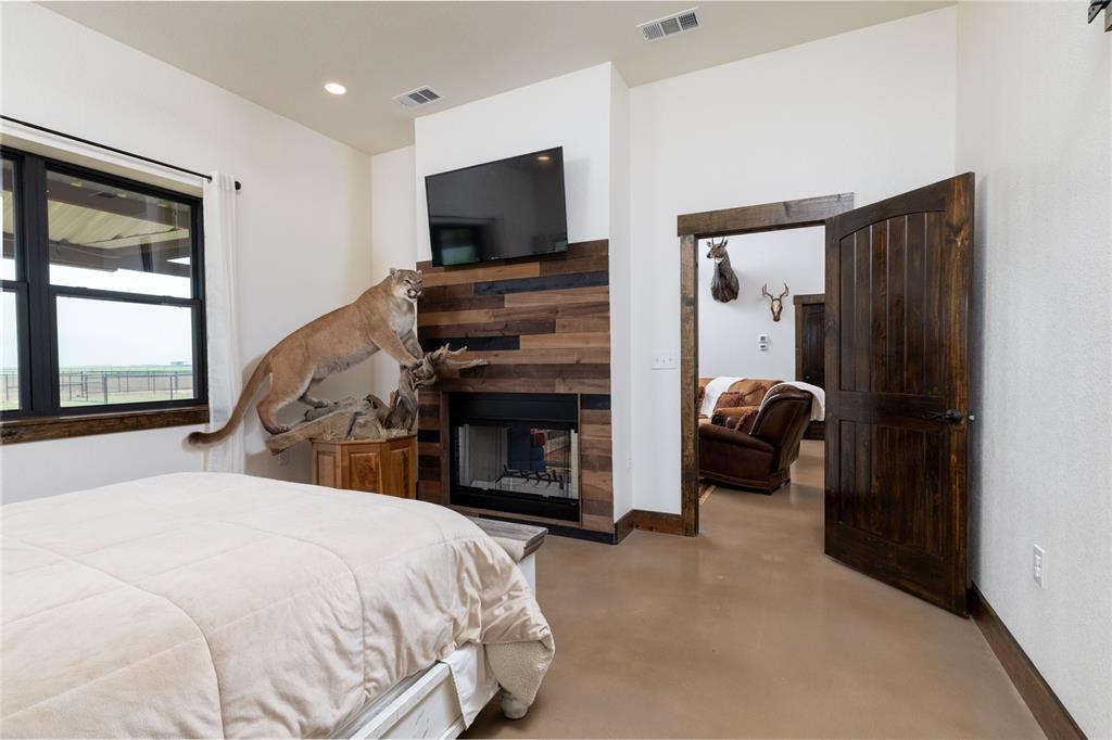 5543 Gray Road Nocona, TX 76255 - Photo 14 of 36 a spacious bedroom with a bed and a flat screen tv