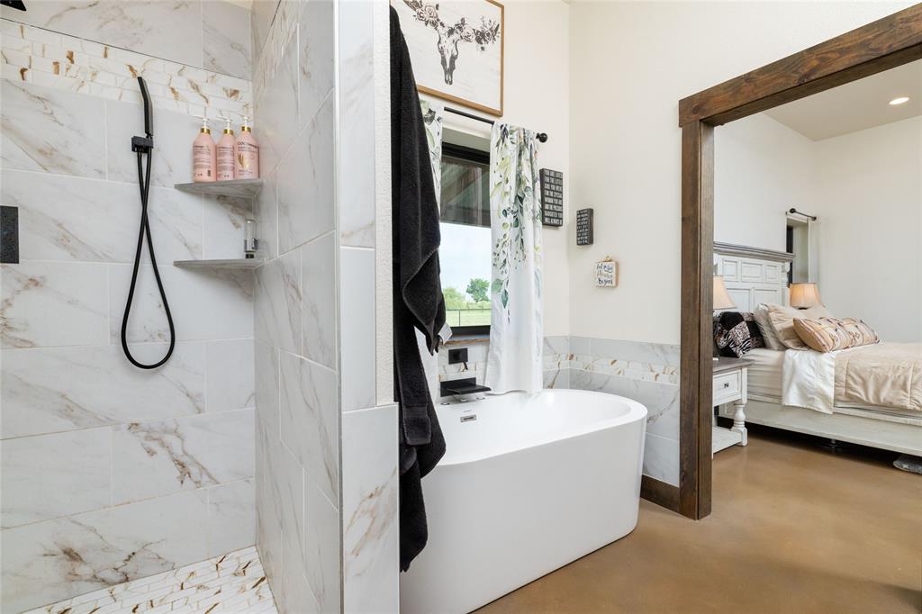 5543 Gray Road Nocona, TX 76255 - Photo 16 of 36 a bathroom with a tub sink and mirror