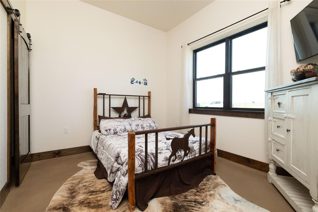 5543 Gray Road Nocona, TX 76255 - Photo 19 of 36 a bed sitting in a bedroom next to a window