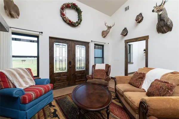 a living room with furniture a flat screen tv and a large window