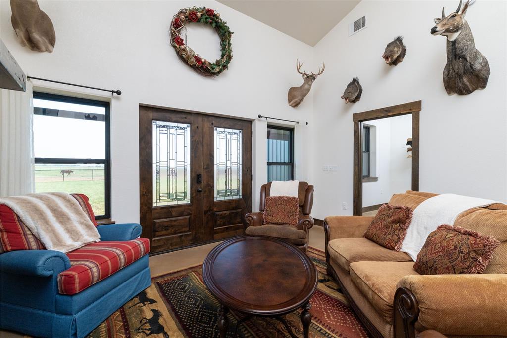 5543 Gray Road Nocona, TX 76255 - Photo 4 of 36 a living room with furniture a flat screen tv and a large window