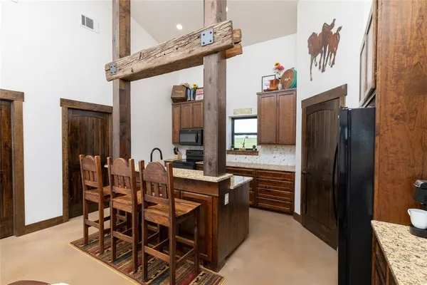 a dining room with furniture a window and kitchen view