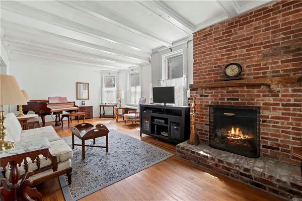 a living room with furniture a fireplace a flat screen tv and a fireplace