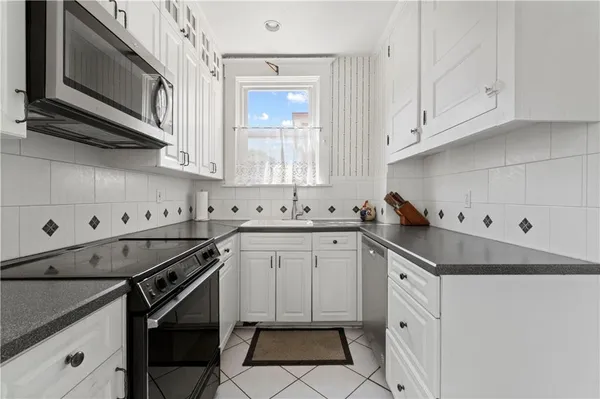 a kitchen with stainless steel appliances cabinets a sink and a stove
