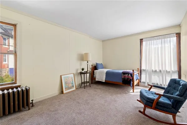 a bedroom with furniture and a window