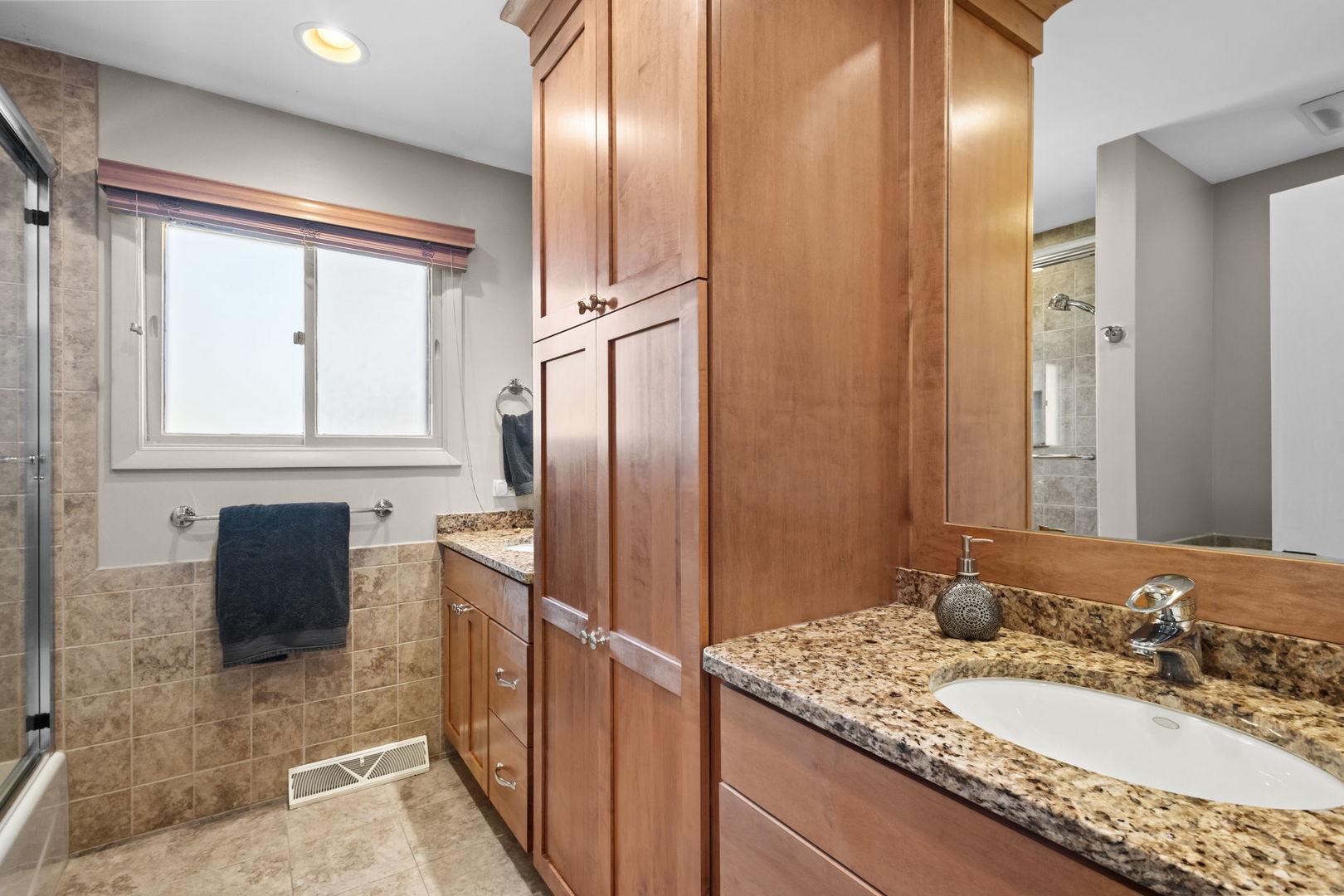 2775 Salceda Drive Northbrook, IL 60062 - Photo 19 of 37 a bathroom with a granite countertop double vanity sink a mirror and a shower