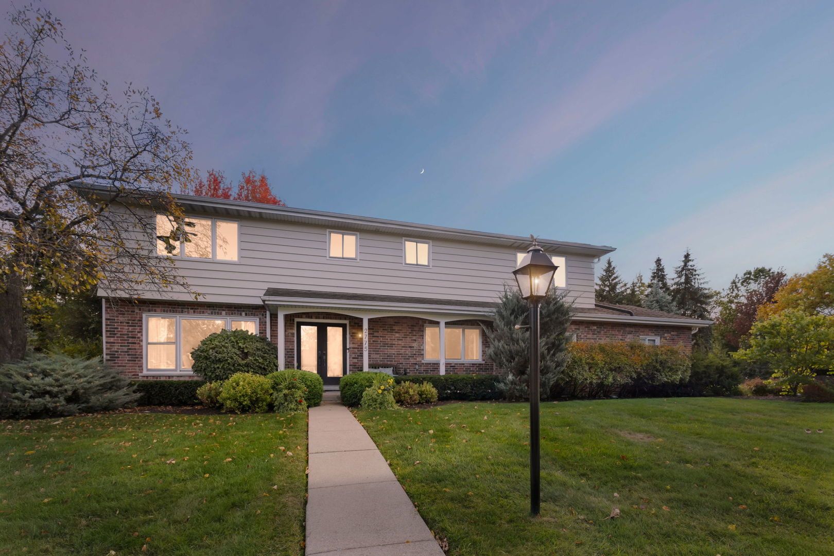 2775 Salceda Drive Northbrook, IL 60062 - Photo 2 of 37 a front view of a house with a garden and yard