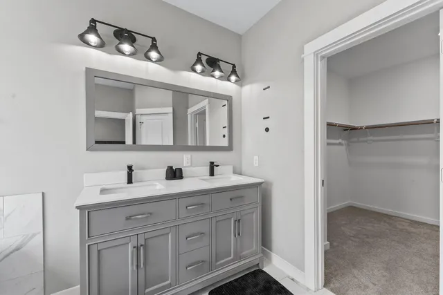 a bathroom with a double vanity sink and mirror