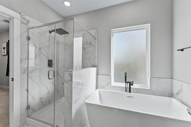 a bathroom with a bathtub and a shower