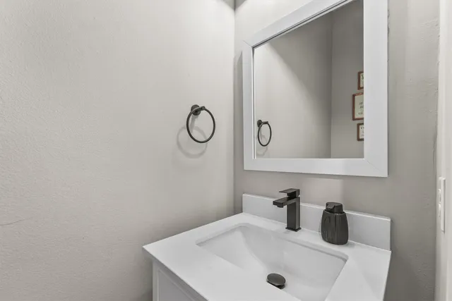 a bathroom with a sink and mirror