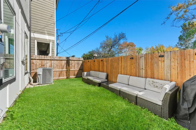a view of a couches in the patio with a small yard
