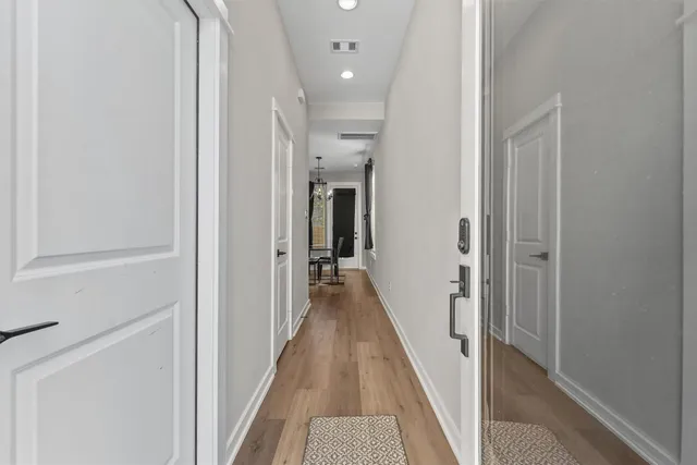 a view of a hallway with the wooden floor