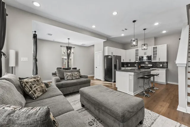 a living room with furniture and kitchen view
