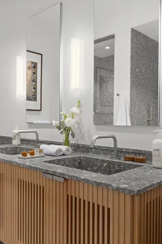 a bathroom with sink granite and a mirror