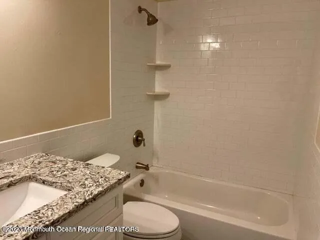 a bathroom with a bathtub and shower