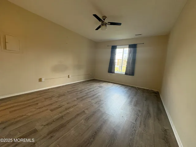 a spacious bathroom with a granite countertop sink a toilet and shower