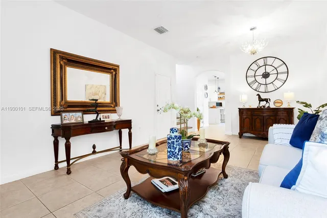a living room with furniture a rug and a wall painting