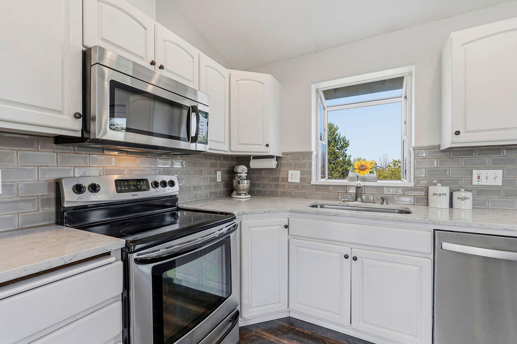 2979 Northeast Sugar Pine Road Prineville, OR 97754 - Photo 6 of 31 a kitchen with cabinets stainless steel appliances a sink and a stove